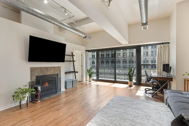 130 S Canal St Unit 624, Chicago, IL 60606 - living area with a high ceiling, wood finished floors, a desk, track lighting, and a fireplace