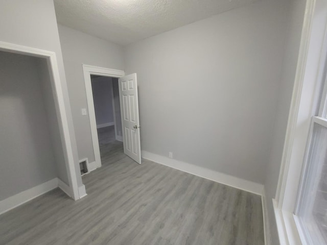 956 2nd Ave, Aurora, IL 60505 - unfurnished bedroom with wood finished floors and a textured ceiling