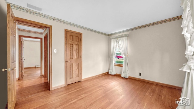 74 Wilmette Dr, Oswego, IL 60543 - spare room featuring light wood-style floors and baseboards