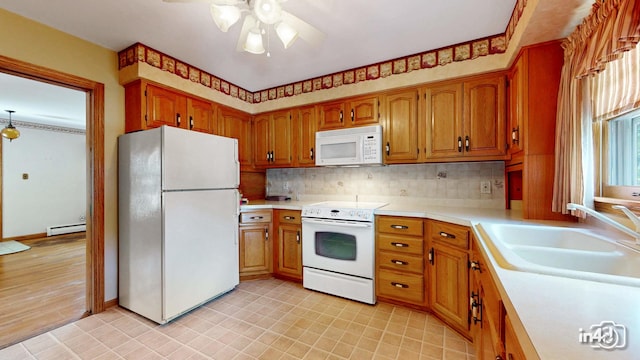 74 Wilmette Dr, Oswego, IL 60543 - kitchen featuring white appliances, ceiling fan, light countertops, brown cabinets, and tasteful backsplash