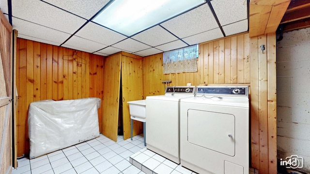 74 Wilmette Dr, Oswego, IL 60543 - laundry room with separate washer and dryer, light tile patterned floors, and wood walls