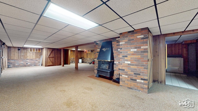 74 Wilmette Dr, Oswego, IL 60543 - finished basement with wooden walls, washer / clothes dryer, carpet flooring, a paneled ceiling, and a wood stove