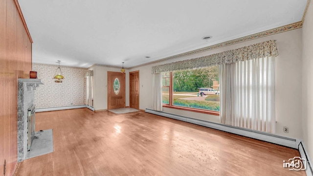 74 Wilmette Dr, Oswego, IL 60543 - foyer entrance with a baseboard radiator, wallpapered walls, wood finished floors, and crown molding