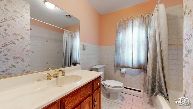 74 Wilmette Dr, Oswego, IL 60543 - bathroom with a baseboard radiator, vanity, tile patterned flooring, tile walls, and shower / bathtub combination with curtain