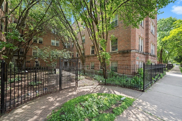 837 E 52nd St Unit 3, Chicago, IL 60615 - view of front of house featuring brick siding, a fenced front yard, and a gate