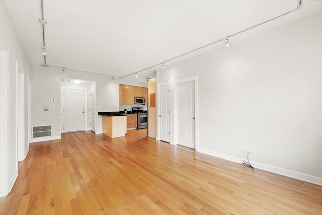 837 E 52nd St Unit 3, Chicago, IL 60615 - unfurnished living room featuring rail lighting and light wood-type flooring