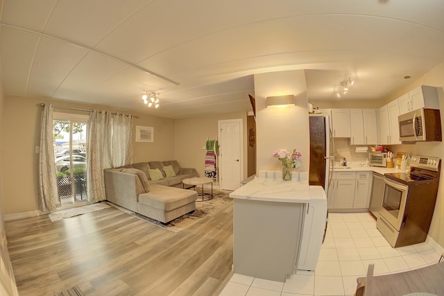 3959 W 104th St Unit 1-A, Chicago, IL 60655 - kitchen featuring stainless steel appliances, open floor plan, light stone countertops, and light wood finished floors