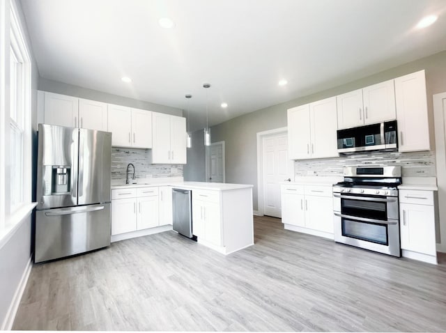1509 Saint Charles Rd, Maywood, IL 60153 - kitchen featuring stainless steel appliances, backsplash, light countertops, a peninsula, and white cabinets