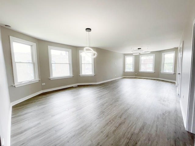 1509 Saint Charles Rd, Maywood, IL 60153 - spare room featuring wood finished floors and a chandelier