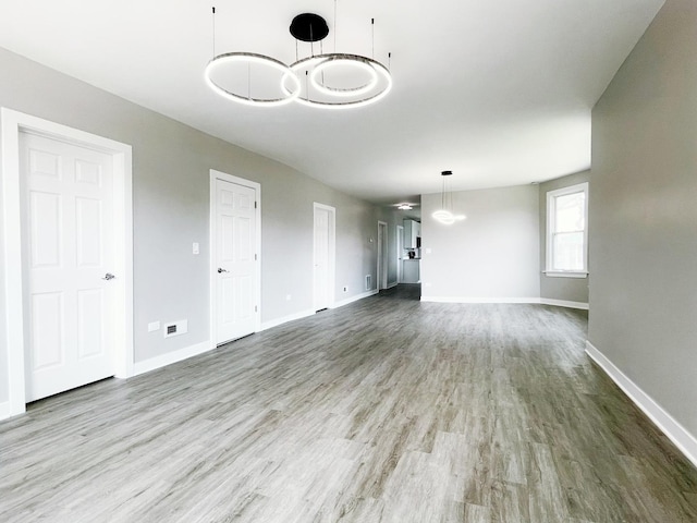 1509 Saint Charles Rd, Maywood, IL 60153 - unfurnished living room with wood finished floors and baseboards