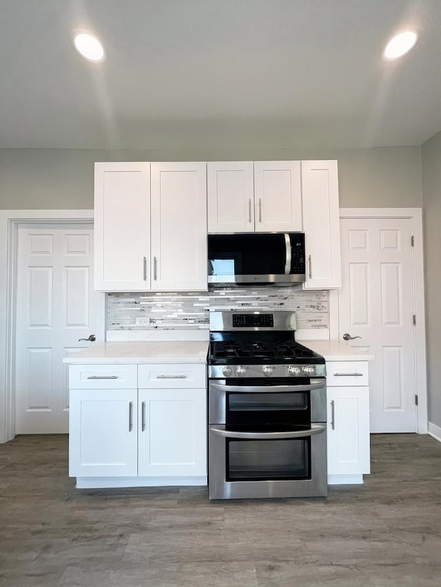 1509 Saint Charles Rd, Maywood, IL 60153 - kitchen with stainless steel appliances, white cabinets, light countertops, decorative backsplash, and recessed lighting
