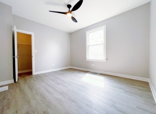 1509 Saint Charles Rd, Maywood, IL 60153 - spare room with a ceiling fan and wood finished floors