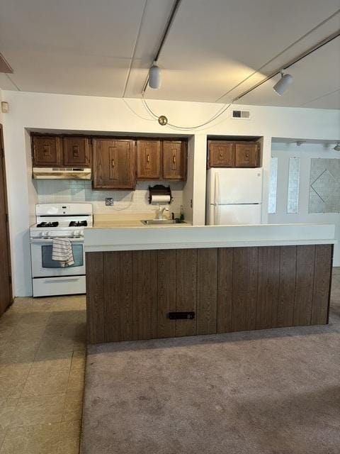 1705 Kenneth Cir Unit 1705, Elgin, IL 60120 - kitchen featuring white appliances, under cabinet range hood, light countertops, and rail lighting