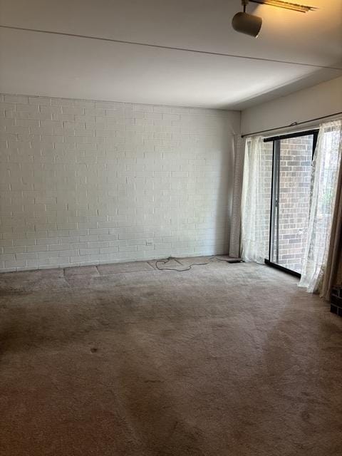 1705 Kenneth Cir Unit 1705, Elgin, IL 60120 - carpeted empty room with concrete block wall
