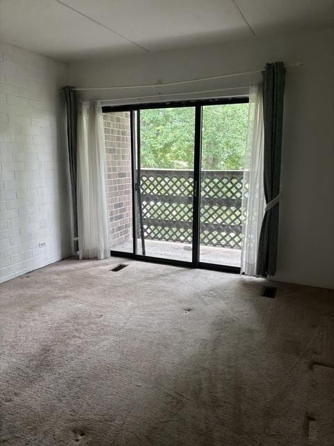1705 Kenneth Cir Unit 1705, Elgin, IL 60120 - unfurnished room with carpet floors and concrete block wall