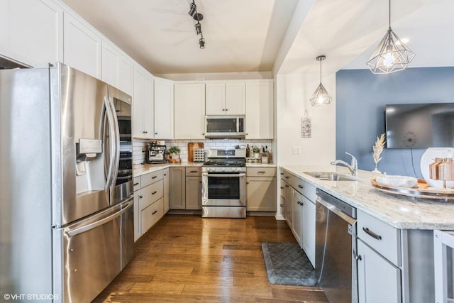 6825 179th St, Tinley Park, IL 60477 - kitchen with stainless steel appliances, a peninsula, dark wood-style flooring, tasteful backsplash, and decorative light fixtures
