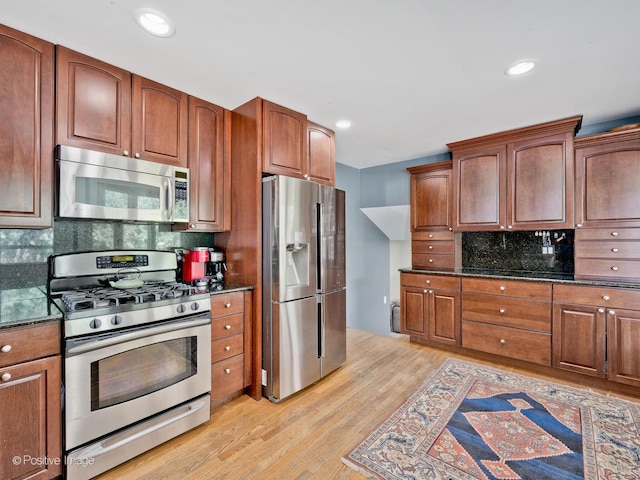 2246 Strawberry Ln, Glenview, IL 60026 - kitchen featuring stainless steel appliances, light wood finished floors, tasteful backsplash, dark stone countertops, and recessed lighting