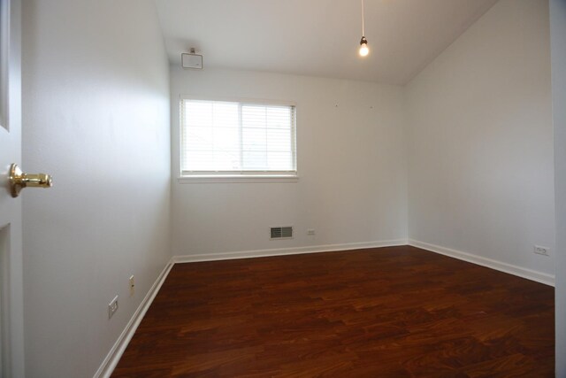 1061 Franklin St, Mundelein, IL 60060 - empty room featuring dark wood-style floors and vaulted ceiling