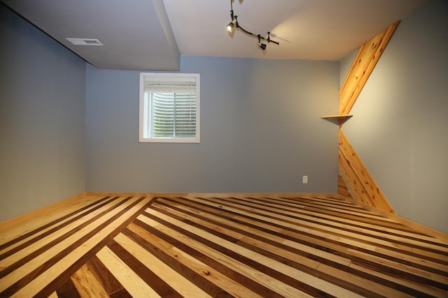 1061 Franklin St, Mundelein, IL 60060 - unfurnished bedroom featuring wood finished floors and track lighting