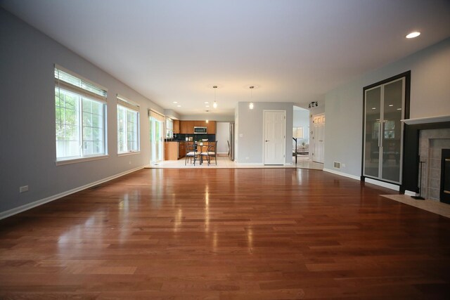 1061 Franklin St, Mundelein, IL 60060 - unfurnished living room with dark wood-style floors, recessed lighting, and a fireplace
