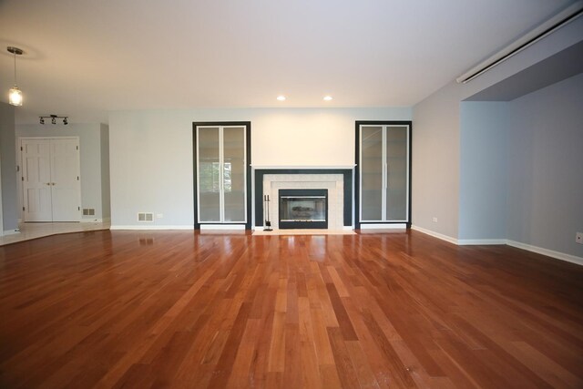 1061 Franklin St, Mundelein, IL 60060 - unfurnished living room featuring wood finished floors, a glass covered fireplace, and recessed lighting