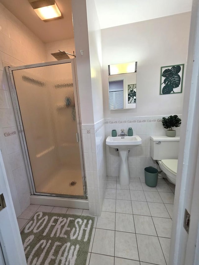 727 N Fordham Ave, Aurora, IL 60506 - full bathroom with tile walls, tile patterned floors, a stall shower, and a wainscoted wall