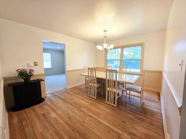 727 N Fordham Ave, Aurora, IL 60506 - dining space featuring a chandelier, hardwood / wood-style flooring, and wainscoting