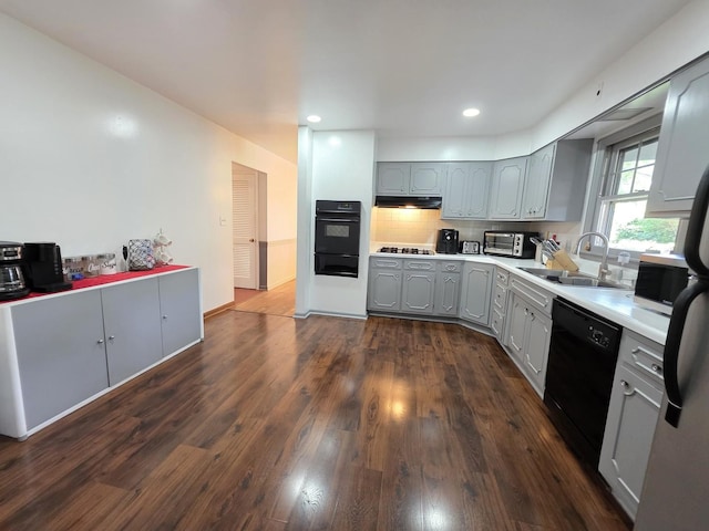727 N Fordham Ave, Aurora, IL 60506 - kitchen with black appliances, gray cabinetry, a warming drawer, under cabinet range hood, and light countertops
