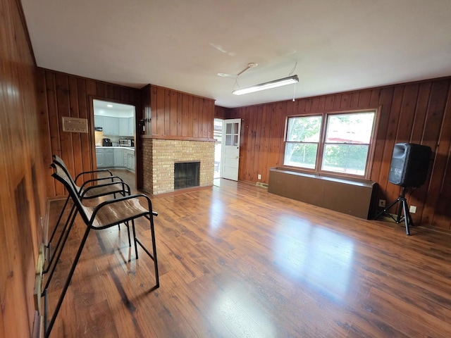 727 N Fordham Ave, Aurora, IL 60506 - living room featuring wooden walls, wood finished floors, and a fireplace