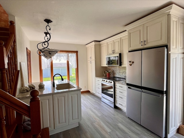 1116 E 2300 N Rd, Danforth, IL 60930 - kitchen with appliances with stainless steel finishes, wood finished floors, tasteful backsplash, and hanging light fixtures