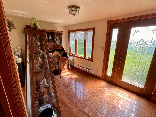 1116 E 2300 N Rd, Danforth, IL 60930 - foyer entrance with a baseboard radiator, hardwood / wood-style floors, and a textured ceiling