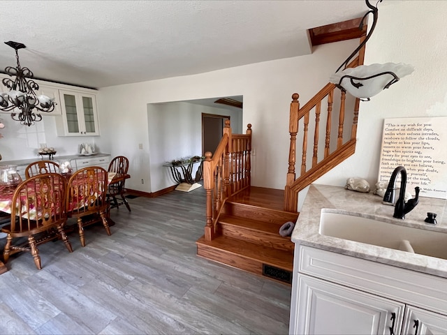 1116 E 2300 N Rd, Danforth, IL 60930 - dining area featuring stairs, light wood finished floors, and a chandelier