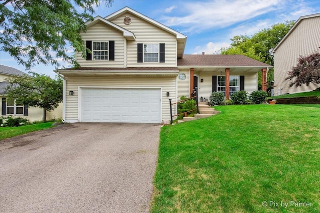 903 Pin Oak Cir, Cary, IL 60013 - view of front facade featuring an attached garage, a front yard, driveway, and a porch