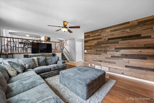 903 Pin Oak Cir, Cary, IL 60013 - living area with stairs, wood finished floors, wood walls, and ceiling fan