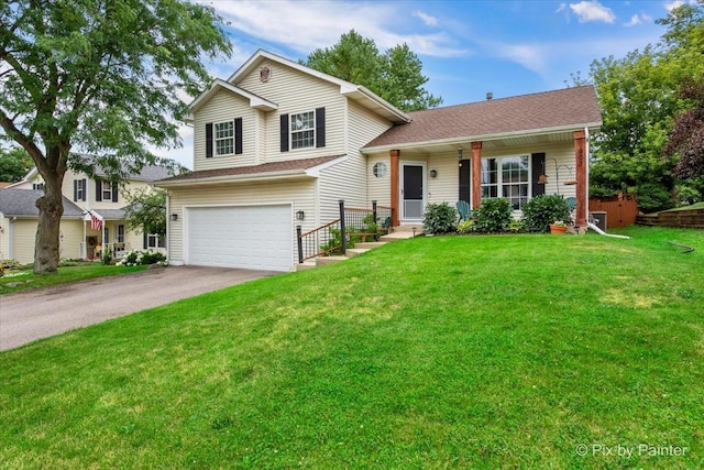 903 Pin Oak Cir, Cary, IL 60013 - split level home with a garage, driveway, and a front yard