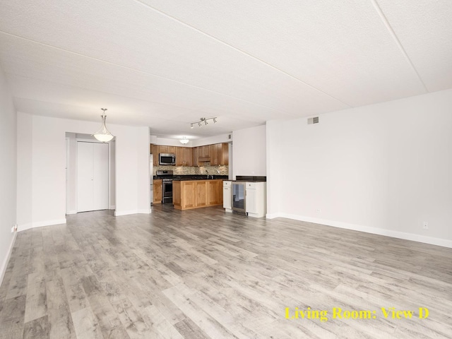 8540 W Foster Ave Unit 403, Norridge, IL 60706 - unfurnished living room with wine cooler, light wood-style floors, and rail lighting