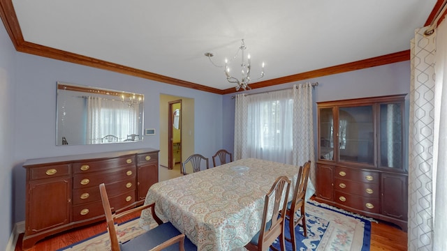3354 N Overhill Ave, Chicago, IL 60634 - dining area featuring a chandelier, ornamental molding, and light wood finished floors