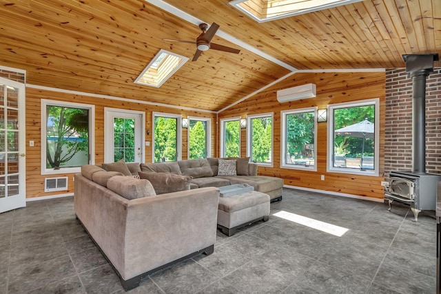 2319 Hutchison Rd, Flossmoor, IL 60422 - living area with a skylight, plenty of natural light, a wood stove, wooden walls, and vaulted ceiling