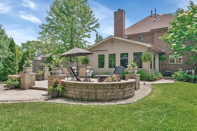 2319 Hutchison Rd, Flossmoor, IL 60422 - rear view of house featuring a patio, a yard, a chimney, and brick siding