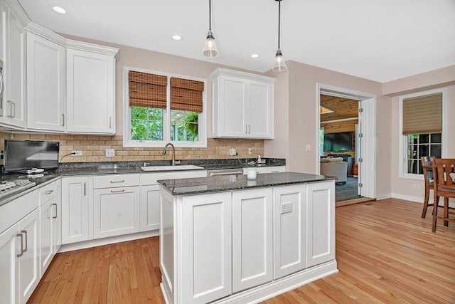 2319 Hutchison Rd, Flossmoor, IL 60422 - kitchen with decorative backsplash, a center island, light wood-type flooring, white cabinetry, and recessed lighting