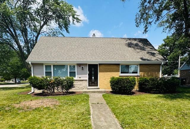 8954 Southfield Dr, Bridgeview, IL 60455 - view of front facade featuring a front yard, brick siding, and a shingled roof