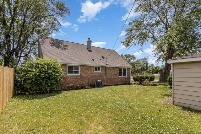 8954 Southfield Dr, Bridgeview, IL 60455 - back of property featuring a chimney, roof with shingles, and brick siding