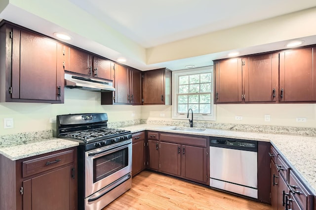 918 Carol Ln, Crete, IL 60417 - kitchen with stainless steel appliances, under cabinet range hood, light wood finished floors, recessed lighting, and light stone countertops
