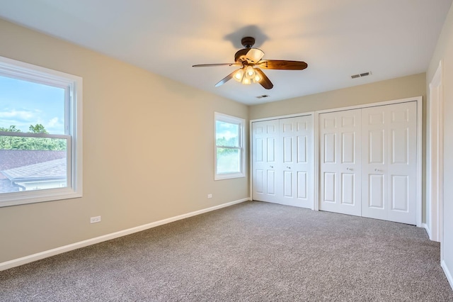 918 Carol Ln, Crete, IL 60417 - unfurnished bedroom with two closets, carpet flooring, and a ceiling fan
