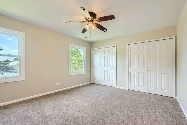 918 Carol Ln, Crete, IL 60417 - unfurnished bedroom featuring two closets, carpet, and ceiling fan