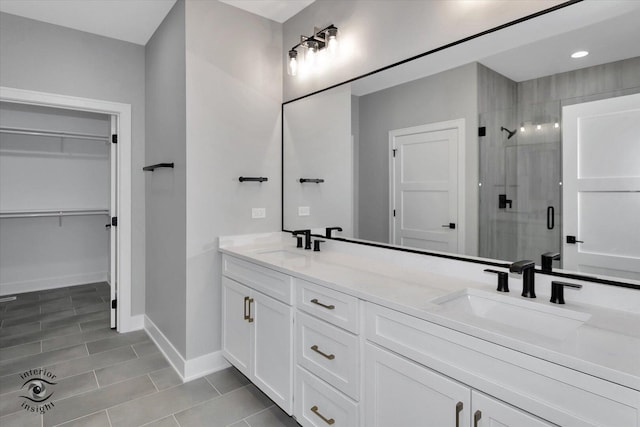 16451 Kayla Dr, Lemont, IL 60439 - bathroom featuring a shower stall, double vanity, a walk in closet, and tile patterned flooring