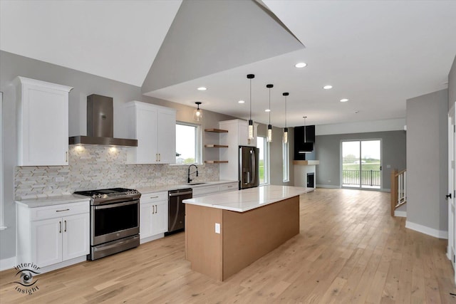 16451 Kayla Dr, Lemont, IL 60439 - kitchen featuring ventilation hood, appliances with stainless steel finishes, a kitchen island, tasteful backsplash, and light wood-type flooring