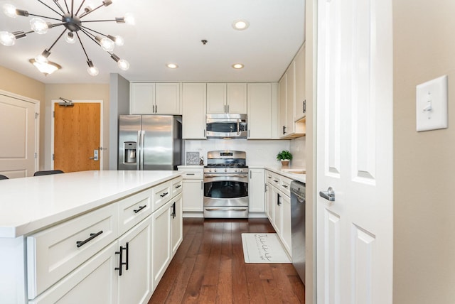 1199 E Port Clinton Rd Unit 305, Vernon Hills, IL 60061 - kitchen featuring appliances with stainless steel finishes, recessed lighting, light countertops, white cabinets, and dark wood-type flooring