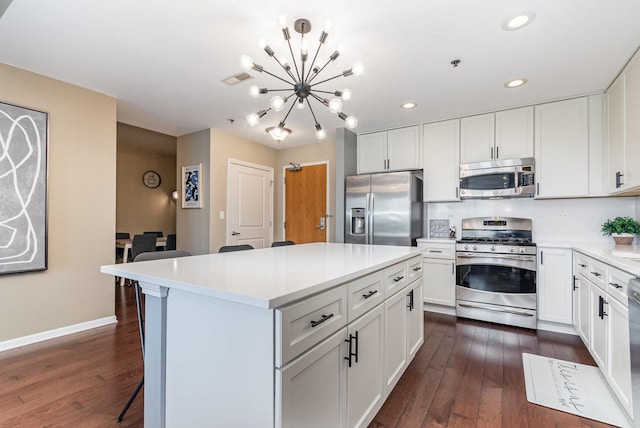 1199 E Port Clinton Rd Unit 305, Vernon Hills, IL 60061 - kitchen with appliances with stainless steel finishes, a chandelier, dark wood-style flooring, a kitchen island, and recessed lighting