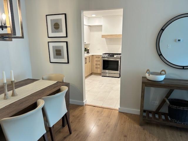 110 S Dunton Ave Unit 4G, Arlington Heights, IL 60005 - dining area with light wood-style flooring and a chandelier